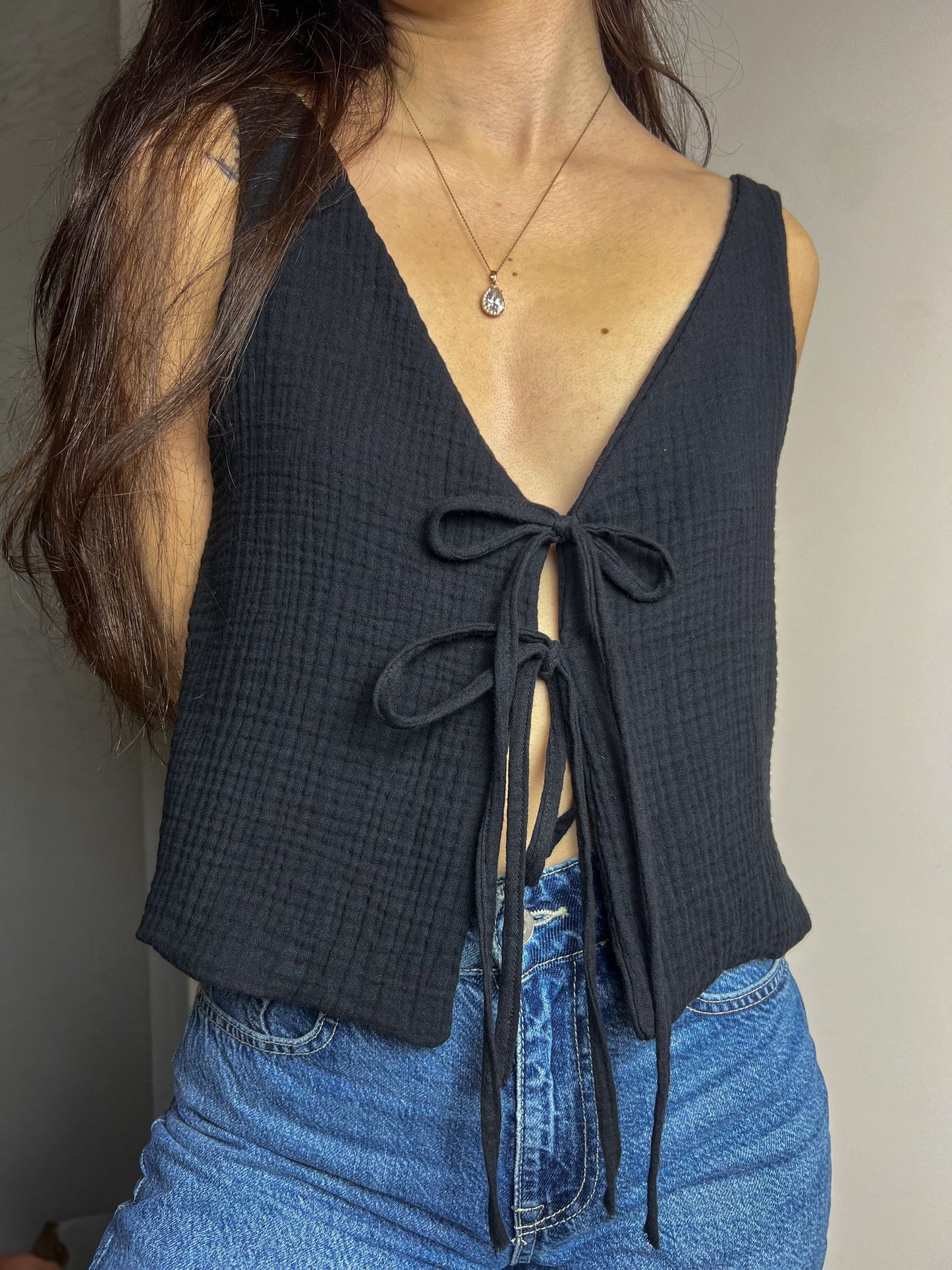 Close-up of the finished Lani front tie top sewn in muslin showing the deep neckline and front tie detail