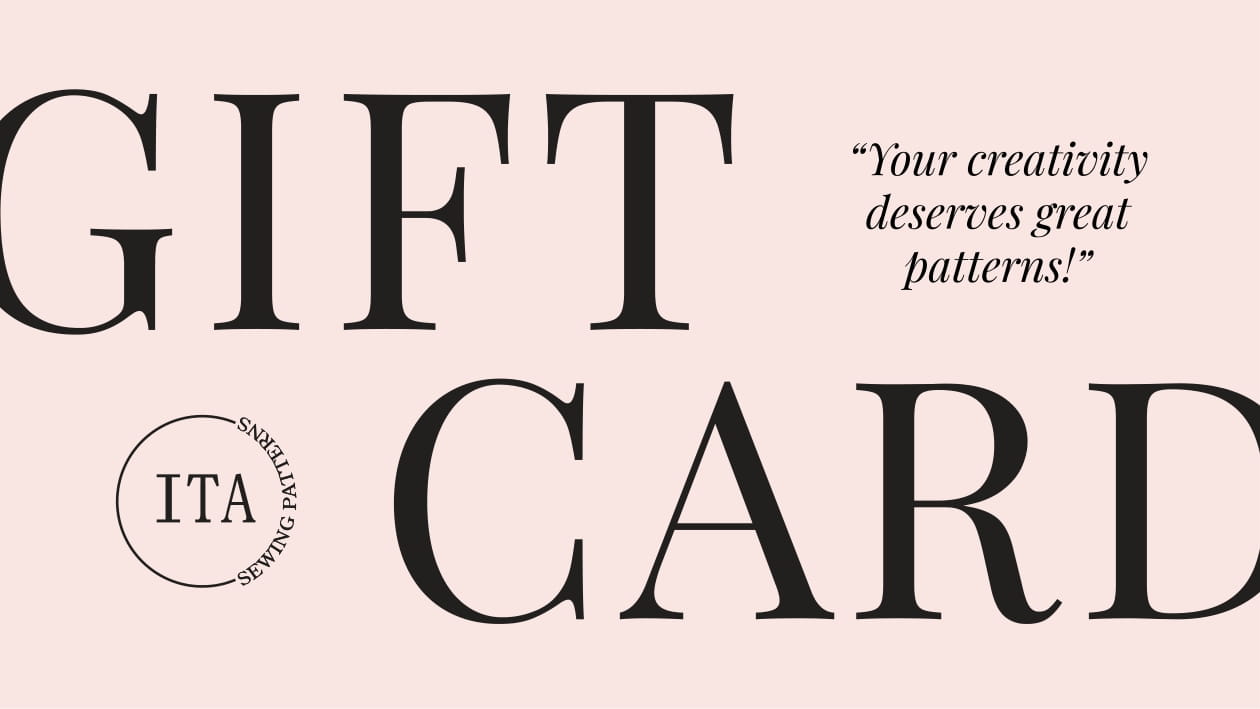 Gift card design with 'ITA' branding and text on a pink background