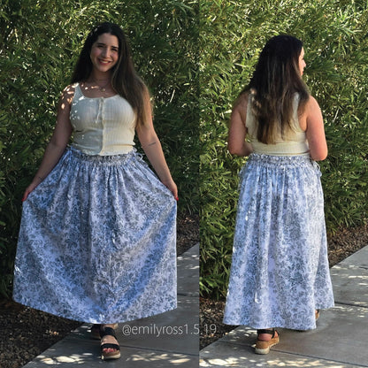 A woman modeling a sleeveless white ribbed top and a full light blue floral maxi skirt, shown in front and back views outdoors against a green hedge.