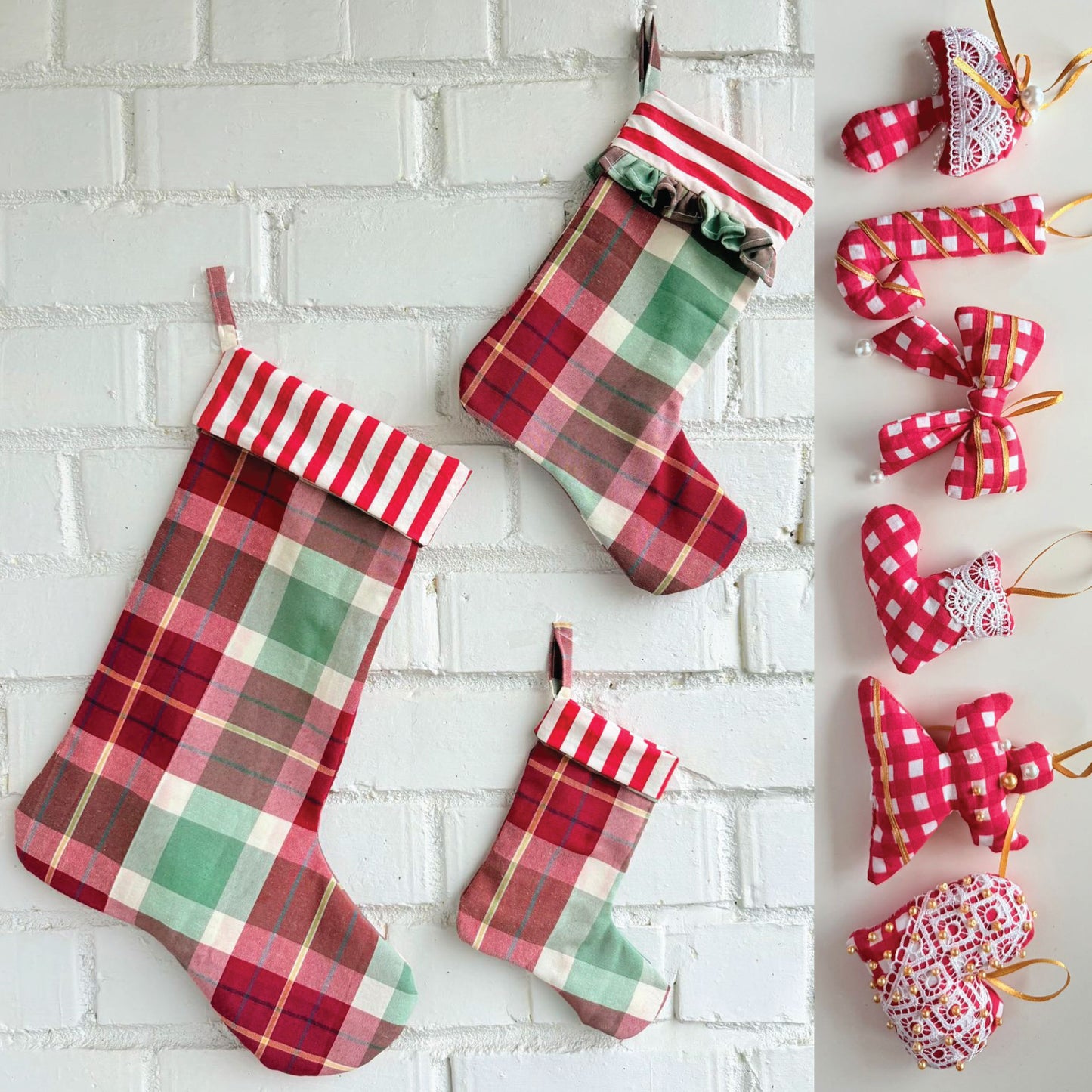 Three plaid Christmas stockings in red, green, and white hang on a white brick wall, with a vertical strip of matching fabric ornaments on the right including bows, candy canes, hearts, and stars.