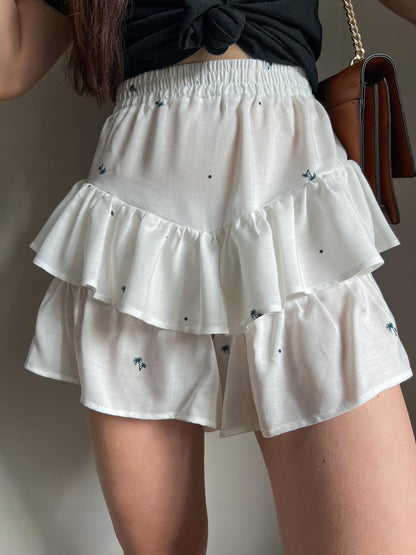 KIKI ruffle shorts with elastic waistband showing layered ruffles and lightweight summer fabric.