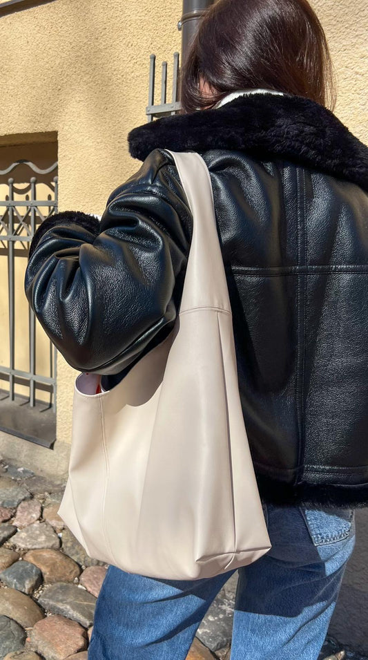 finished nova handbag leather slouchy bag worn on the shoulder showing soft structure and minimalist design.