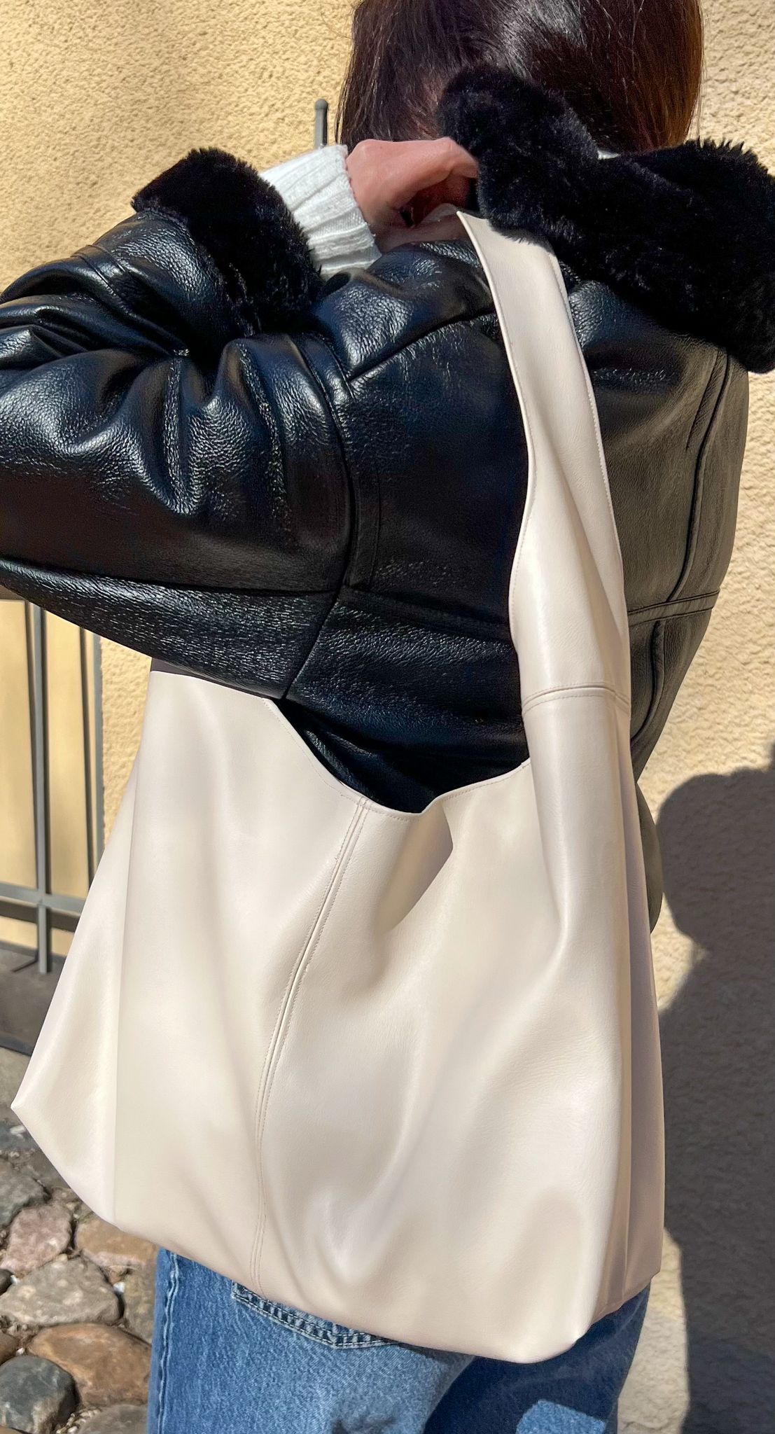 back view of the nova handbag worn on the shoulder showing slouchy leather shape and wide strap from the sewing pattern.