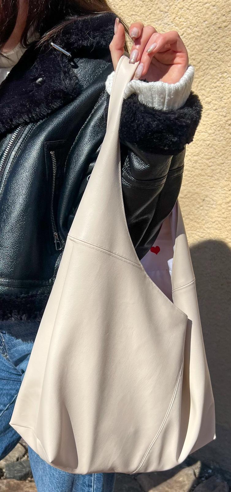 finished nova handbag worn on the shoulder made from leather showing slouchy shape and clean seams from the sewing pattern.