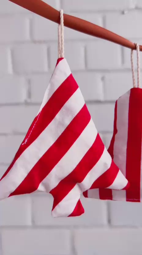 Video showing red and white fabric Christmas ornaments hanging on a string made from a sewing pattern