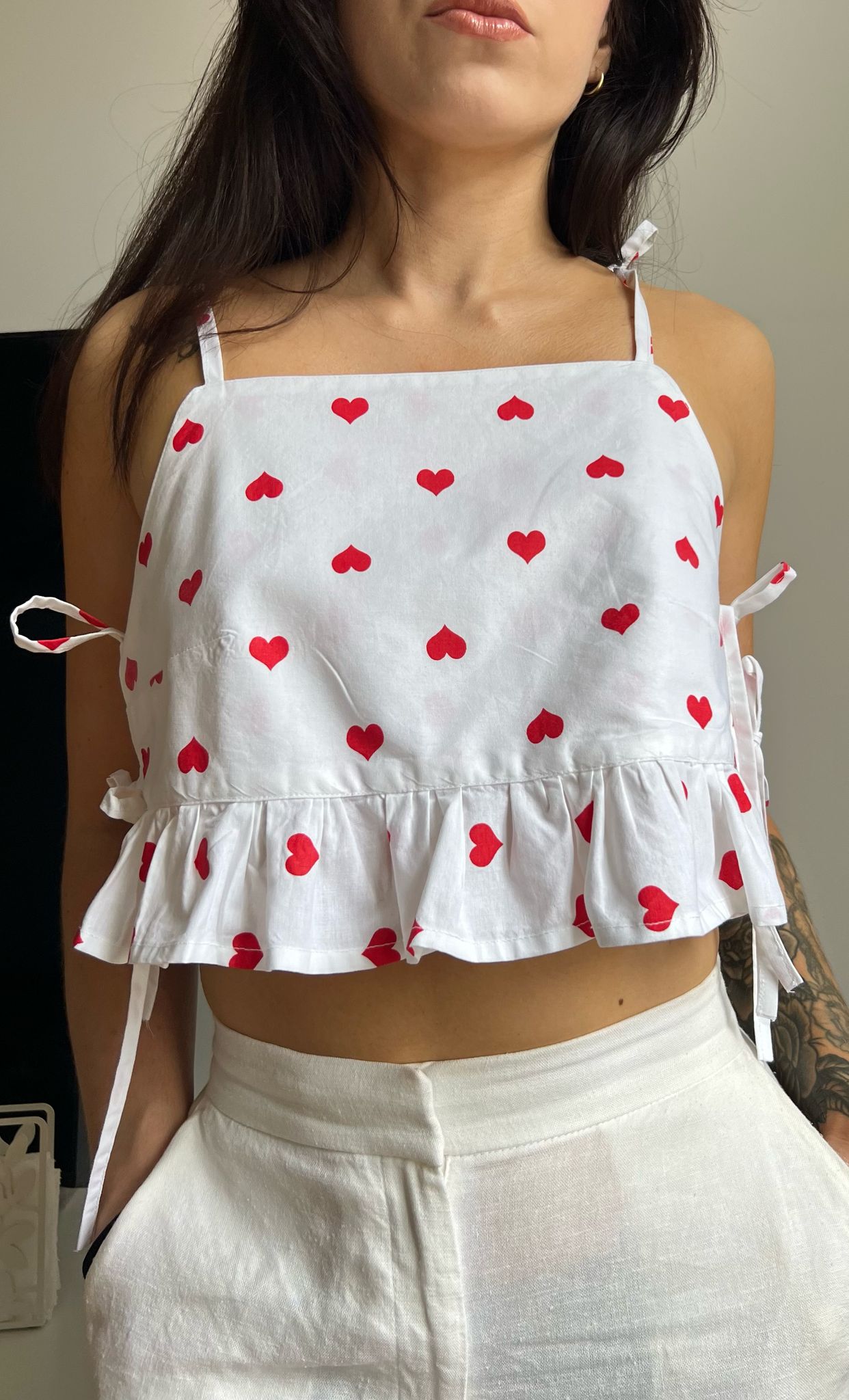 Rosie ruffle top sewing pattern showing front view of finished garment with ruffle hem and shoulder ties.