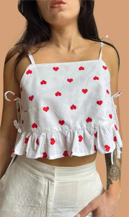 Rosie ruffle top sewing pattern with heart print fabric shown on finished garment.