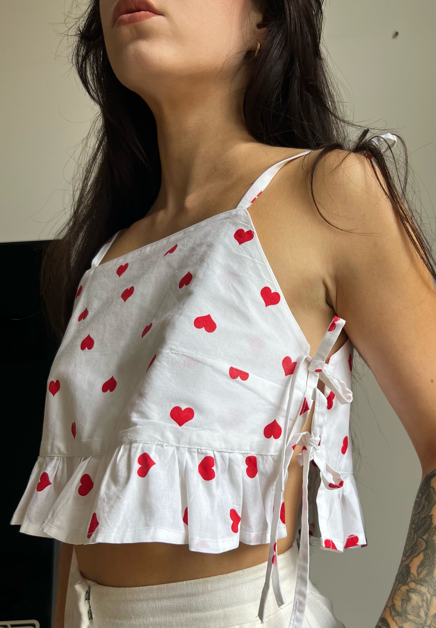 Rosie ruffle top sewing pattern showing side tie detail with heart print fabric.