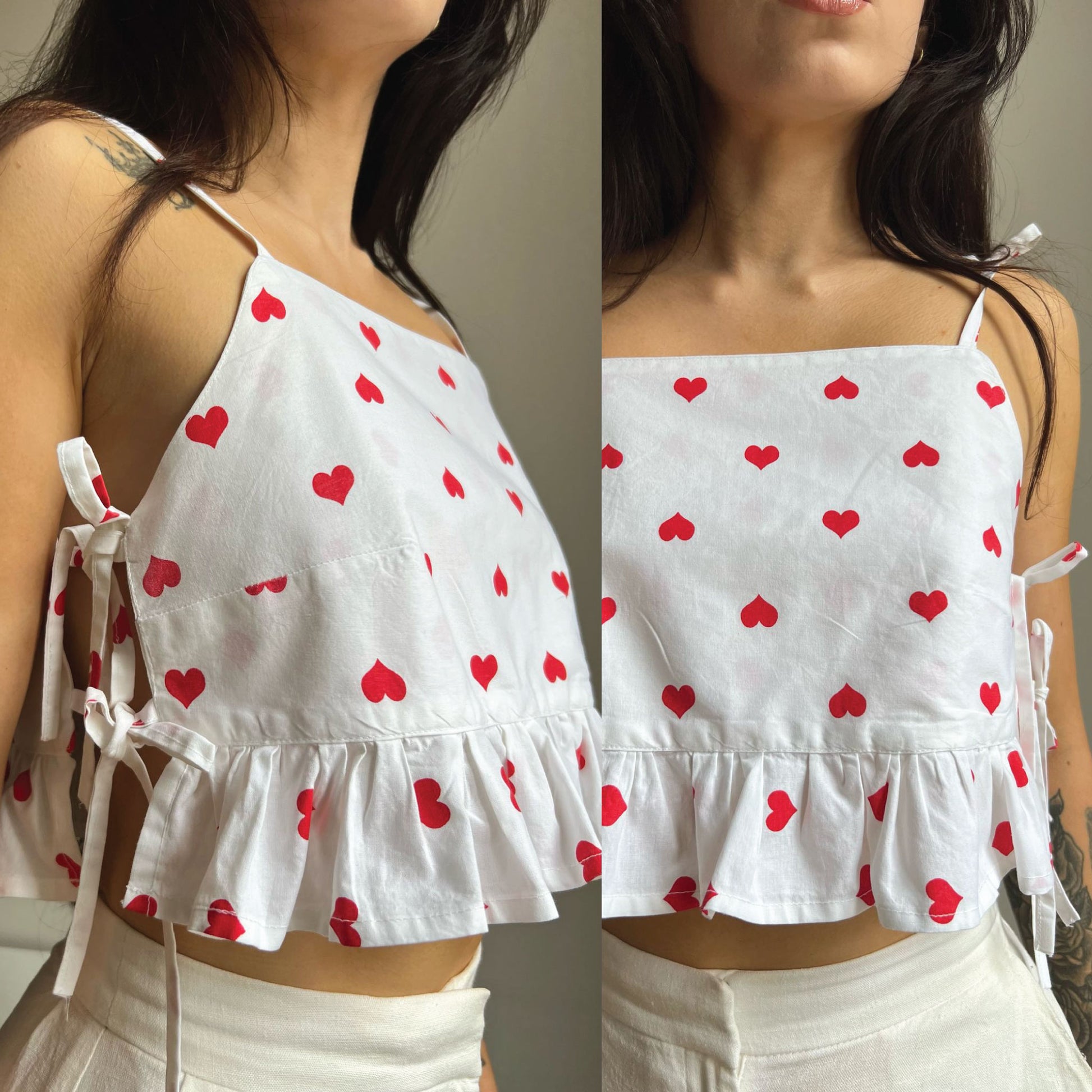 A white spaghetti-strap crop top with a red heart pattern, featuring a ruffled hem and side tie details, shown on a model in a split-screen view.