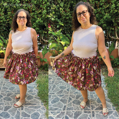 A side-by-side outdoor photo of a woman modeling a floral print skirt with a white sleeveless top. The setting is a garden with green foliage and a stone path.