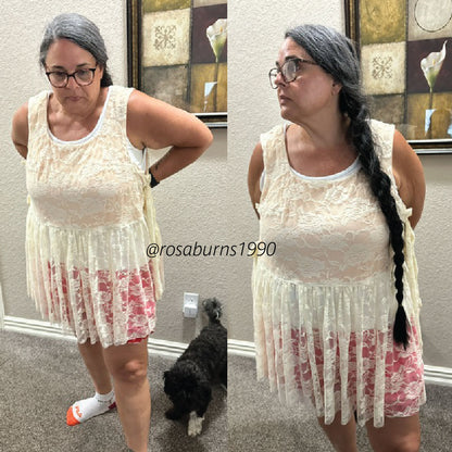 A side-by-side comparison photo of a woman modeling a sleeveless cream lace mini dress with a pink floral skirt overlay. The image shows her from the waist down in two poses, with a small black dog on the carpet in the background.
